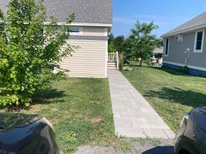 a yard with a house and a driveway at The Phoebe - 65 Butternut in Cherry Valley