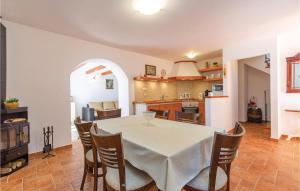 a kitchen and dining room with a table and chairs at 2 Bedroom Beautiful Home In Barci in Barci
