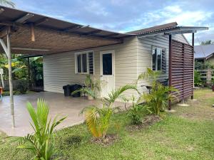 a small house with a porch and a patio at Fare Hoa Moorea in Afareaitu +8 photos