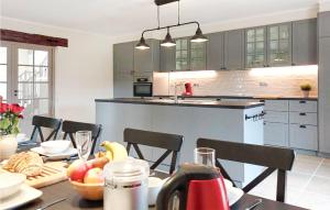 a kitchen with a table with a bowl of fruit on it at Awesome Home In Lussas Et Nontronneau in Lussas-et-Nontronneau