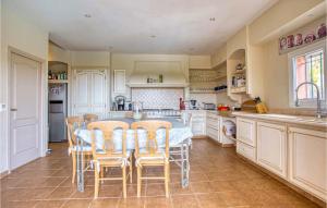 a large kitchen with a table and chairs in it at Stunning Home In Les Adrets-De-L'estére in Les Adrets de l'Esterel