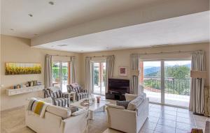 a living room with white furniture and a balcony at Stunning Home In Les Adrets-De-L'estére in Les Adrets de l'Esterel