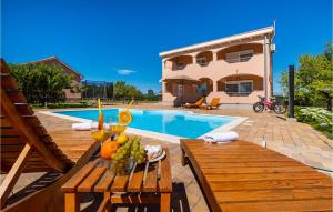 a table with fruit on it next to a pool at Four-Bedroom Holiday Home In Suhovare in Suhovare