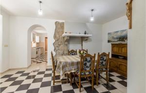 a kitchen and dining room with a table and chairs at Five-Bedroom Holiday Home In Vinjani Donji in Bilopavlovići