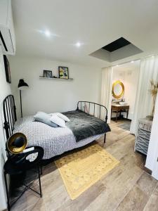 a bedroom with a bed and a chair and a desk at Petite maison indépendante proche Strasbourg in Brumath +8 photos