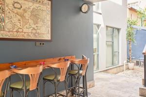 a bar with chairs and a clock on a wall at Nostalgic & Comfortable Historical Home! in Istanbul