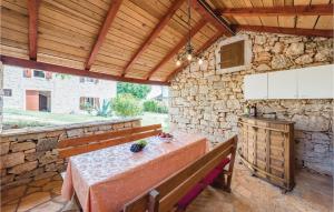 a patio with a table and a stone wall at Holiday Home Markovac 11 in Markovac
