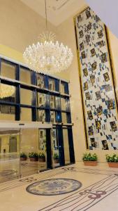 a chandelier in a lobby with a large window at Maidan Al Bait in Makkah