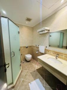 a bathroom with a sink and a toilet at Maidan Al Bait in Makkah +31 photos