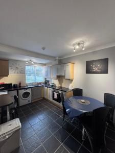 a kitchen with a table and a dining room at Modern Apartment good distance from Dublin City and Airport 4people in Dublin