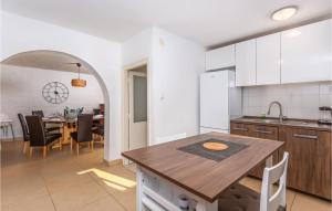 a kitchen with a table and a dining room at 4 Bedroom Pet Friendly Home In Malinska in Malinska