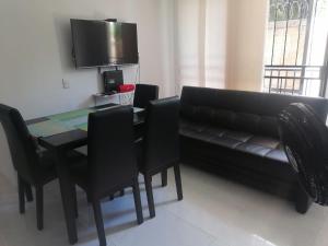 a living room with a couch and a table and chairs at Lilia's House Santa Marta in Santa Marta