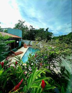 a swimming pool in front of a house at Casa Cica in Ubatuba