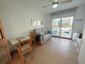 a living room with a couch and a table at Estudio en primera linea de playa in Daimuz