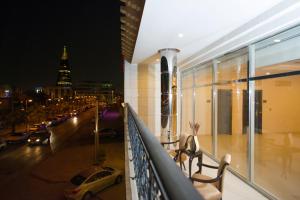 a balcony with a view of a city at night at Voyage Apartments in Riyadh