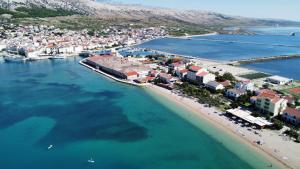 an aerial view of a beach and buildings at Sailor apartments in Pag