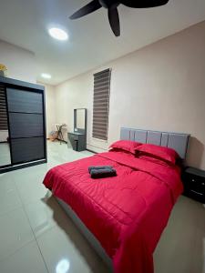a bedroom with a red bed with a red blanket at Atenza Homestay Residensi KLIA Condominium, 4 bedrooms 3 bathrooms , Near KLIA and Sepang F1 in Nilai +18 photos