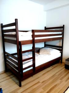 two bunk beds in a room with a wooden floor at PANORAMA Family Apartment 45C, Donovaly in Donovaly