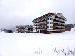 an apartment building in the snow in a field at PANORAMA Family Apartment 45C, Donovaly in Donovaly
