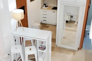 a white table and two stools in a room at Charming Apartment Málaga 40 m² + Internet in Málaga +34 photos