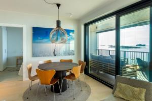 a dining room with a table and chairs at Solara Suite in Kuningatarranta Hanko in Hanko