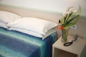 Ένα ή περισσότερα κρεβάτια σε δωμάτιο στο Hotel Lara