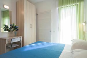 Ένα ή περισσότερα κρεβάτια σε δωμάτιο στο Hotel Lara