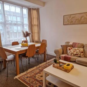 a living room with a table and a couch at 2-Bed Apartment I Hyde Park I Central London in London +50 photos