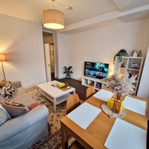 a living room with a couch and a table at 2-Bed Apartment I Hyde Park I Central London in London