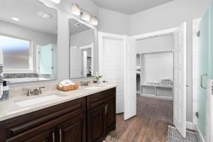a bathroom with two sinks and a large mirror at LUXE Boho Chic5BR Woodbine Round Rock Kalahari in Round Rock +36 photos