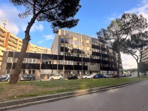 an office building with cars parked in front of it at Urban Chic Luxury Suite Apartments in Rome