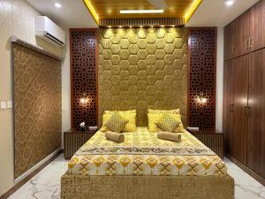 a bedroom with a bed with a yellow bedspread at Exquisite Luxe 2 Bedroom Condo Close to GIGA MALL in Islamabad +33 photos