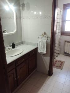 a bathroom with a sink and a mirror and a tub at Casa Alvear - Bed & Breakfast in Tandil