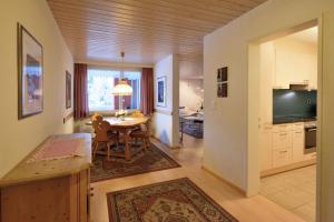 a kitchen and dining room with a table and a television at Ferienwohnung St. Moritz in St. Moritz