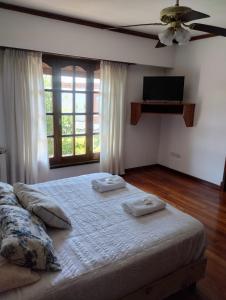a bedroom with a bed with two towels on it at Casa Alvear - Bed & Breakfast in Tandil