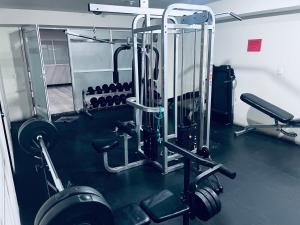 a fitness room with a gym with weights at Penthouse Elysium in Mexico City