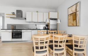a kitchen with a wooden table and chairs at Gudhjem Søpark Lejl 18 in Gudhjem