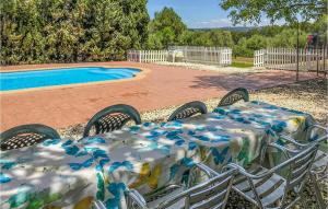 a table and chairs next to a swimming pool at Awesome Home In Ardenya With Wifi in Ardenya +29 photos