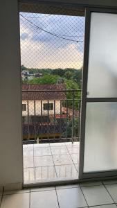 a window in a room with a view of a building at Residencial parque Itaoca in Ananindeua