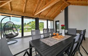 a dining room with a table and chairs at Pet Friendly Home In Vinica Breg in Gorušenjak