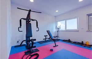 a gym with two treadmills and two exercise bikes at Stunning Home In Zrnovo With Wifi in Korčula