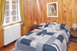 a bedroom with a bed and a horse picture on the wall at Maison charmante au cœur du Chambon-sur-Lignon avec jardin in Le Chambon-sur-Lignon