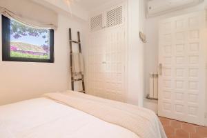 a bedroom with two white doors and a window at Villa Tosalet Pomelo in Jávea