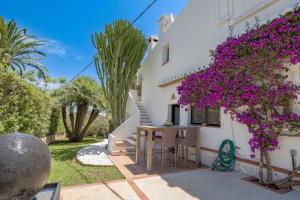 a house with purple flowers on the side of it at Villa Tosalet Pomelo in Jávea