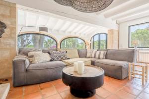 a living room with a couch and a table at Villa Tosalet Pomelo in Jávea