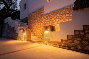 a stone building with stairs and lights on it at Villa Tosalet Pomelo in Jávea