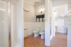 a bathroom with a toilet and a walk in shower at Villa Tosalet Pomelo in Jávea