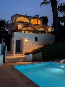 a large house with a swimming pool in front of it at Villa Tosalet Pomelo in Jávea