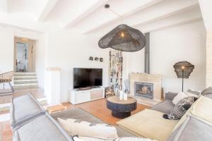 a living room with a couch and a fireplace at Villa Tosalet Pomelo in Jávea