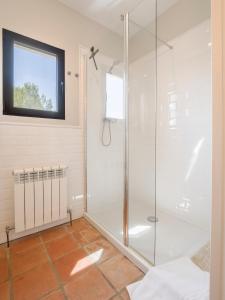 a glass shower in a bathroom with a window at Villa Tosalet Pomelo in Jávea